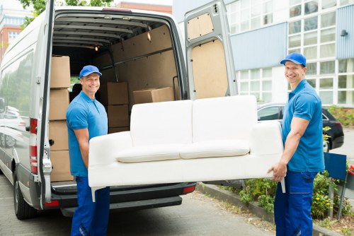 Student moving boxes into storage in Sutton